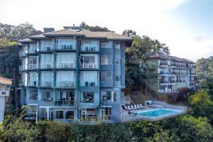 a large apartment building with a swimming pool at Mount Blue Kandy in Kandy