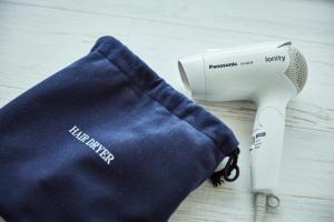 a hair dryer sitting next to a blue cloth at Wakanoura Nature Resort Epicharis in Wakayama