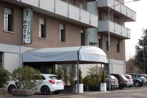 a white van parked in front of a building at Tiby Hotel in Modena
