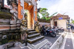 a group of motorcycles parked outside of a building at Gatra Ubud Inn in Ubud