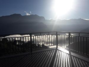 een balkon met een hek en uitzicht op de zon bij Alishan Shanyunhua B&B Homestay in Meishan