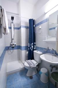 a blue and white bathroom with a toilet and a sink at Hotel Loutraki in Loutraki +36 photos