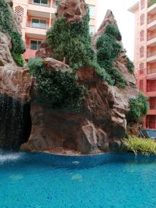 a water slide at a hotel with a waterfall at Seven Seas Jomtien Dream in Jomtien Beach