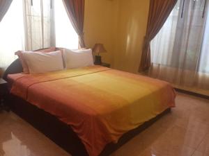 a bedroom with a large bed with a yellow blanket at La Sirène lovely apartment Fisherman Village in Bophut