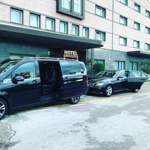 a van and a car parked in front of a hotel at Casa Vacanze Isabella in Aliano