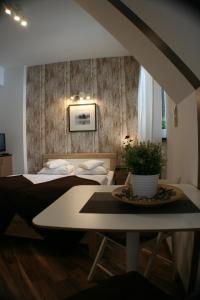 ザコパネにあるApartamenty Centrum 2 Zakopaneのベッドルーム1室(ベッド2台、鉢植えのテーブル付)