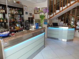 a bar in a restaurant with a counter at Hotel Gioiella in Rimini