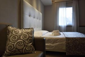 ein Schlafzimmer mit einem Bett, einem Kissen und einem Fenster in der Unterkunft Hotel Riposo in San Pellegrino Terme
