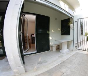 a room with a window and a bench on a patio at J&B - Beachside Studio Apartment in Makarska