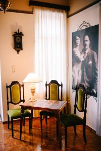 a dining room with a table and two chairs at Xylokastro Antique in Xylokastron