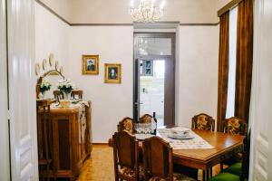 a dining room with a table and chairs and a chandelier at Xylokastro Antique in Xylokastro