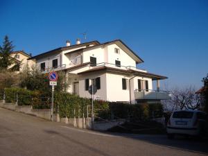 a large white house on the side of a street at Spacious Villa with Garden in Gemmano in Gemmano