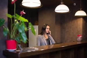 a woman talking on a cell phone in a mirror at Hotel 39 in Lviv