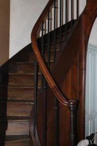 a wooden spiral staircase with a wooden stair case at Appartement au calme Centre Ville à 2 pas du vieux marché in La Rochelle