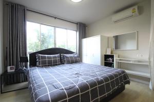 a bedroom with a bed and a large window at Dcondo Kathu Patong Phuket by Suna in Kathu +30 photos