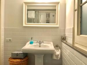 y baño con lavabo blanco y espejo. en Rosselló Apartment, en Barcelona