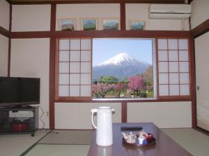 a view of a mountain from a room with a window at Maruyaso in Fujikawaguchiko