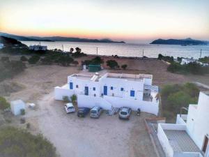 an aerial view of a house with cars parked in front at Vigles in Adamantas