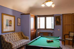 a living room with a pool table and a couch at Villa Trigona in Piazza Armerina