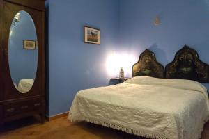 a bedroom with a bed and a dresser at Villa Trigona in Piazza Armerina