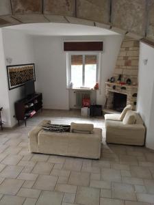 a large living room with two couches and a fireplace at Villa Ada in Torre Colimena