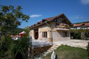 a house with a balcony on the side of it at Casa de Artes Guest House in Balchik