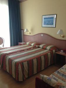 Postel nebo postele na pokoji v ubytování Hotel Harry's