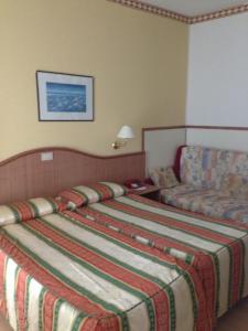 Postel nebo postele na pokoji v ubytování Hotel Harry's