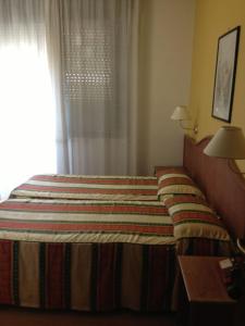 Postel nebo postele na pokoji v ubytování Hotel Harry's