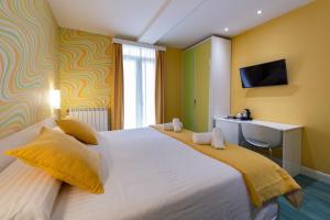 
a hotel room with two beds and a television at Ur-Alde in San Sebastián
