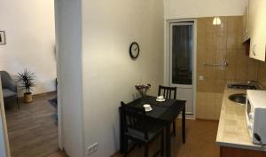 a kitchen with a table and a dining room at Charming apartment in Odesa