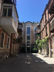 an empty street in front of a building at Charming apartment in Odesa