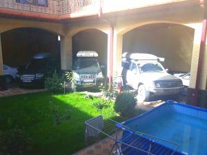 a couple of cars parked in a garage at Like Guest House in Samarkand