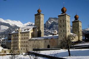 a large castle with two towers in the snow at Brig City Garden Apartment in Brig