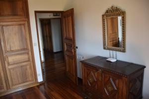 a room with a mirror and a wooden cabinet at Quinta do Bacelo, Casa completa, 4 quartos e piscina in Braga