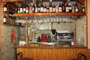 a bar with many bottles of wine on the wall at Apartamentos Haza La Moraleda in Güéjar-Sierra