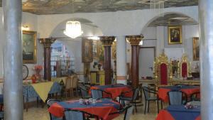 a restaurant with tables and chairs in a room at Hotel Chopin in Fiumicino
