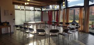 a room with chairs and a table and some windows at Ibis Budget Saint Christol Les Alès in Saint-Christol-lès-Alès