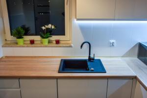 a kitchen counter with a sink and a window at Mogilska Tower + garaż in Kraków