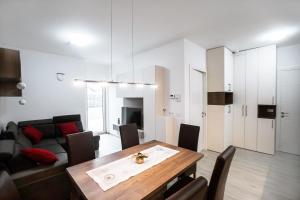 a living room with a table and a couch at APARTMA KATKA Vila Mojca in Kranjska Gora