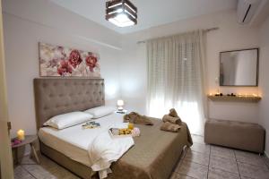 a bedroom with a bed with a teddy bear on it at Holiday House Ioanna in Nea Peramos