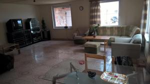 a living room with a couch and a tv at rodiny dom in Rapovce