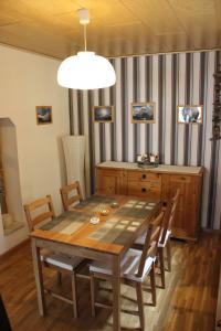Benshausen的住宿－Ferienwohnung Schwarz，一间带木桌和椅子的用餐室