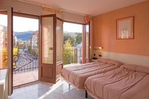 Postel nebo postele na pokoji v ubytování Hotel Avenida