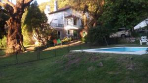 a house with a swimming pool in a yard at Evergreen in La Cumbre