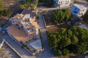 an overhead view of a large house with trees at Milos Apartment in Kalamaki Heraklion