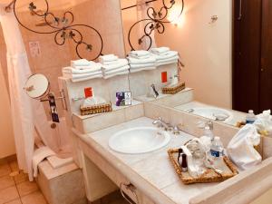 a bathroom with a sink and a mirror at Hotel Hacienda Los Laureles in Oaxaca City