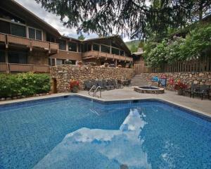 a swimming pool in front of a house at Deluxe Two Bedroom - Aspen Alps #707 in Aspen