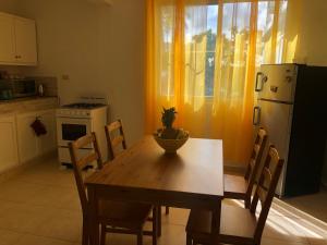 a kitchen with a wooden table with a pineapple on it at Villa Florencia Bavaro in Punta Cana
