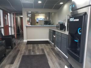 a room with a kitchen with a refrigerator and a counter at Americas Best Value Inn St. Louis Downtown in Saint Louis